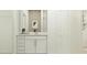 Bright bathroom with a modern vanity, ample storage, and fresh white tones offers a clean, inviting space at 1918 Sarah Ln, Winter Haven, FL 33884
