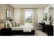 Stylish bedroom with a dark modern decor, a comfortable workspace, and plenty of natural light at 1918 Sarah Ln, Winter Haven, FL 33884