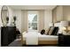 Bright bedroom featuring a large window, stylish decor, and contemporary black furniture at 1918 Sarah Ln, Winter Haven, FL 33884