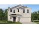 Two-story home features a front-entry two-car garage, landscaped yard, and vertical siding at 1918 Sarah Ln, Winter Haven, FL 33884