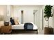 Bright bedroom with a simple bedframe, modern decor, and convenient closet access at 1926 Sarah St, Winter Haven, FL 33884