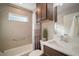 Bright bathroom featuring a bathtub/shower with modern fixtures, and vanity with a white countertop at 5754 Shealy Ave, The Villages, FL 32163