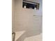 This bathroom features decorative tile work in the shower, a built in bench, and a stylish accent nook at 5754 Shealy Ave, The Villages, FL 32163
