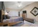 Bedroom features neutral-toned walls, large bed, natural light from a window, and modern decor at 5754 Shealy Ave, The Villages, FL 32163