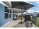 This home features an outdoor seating area, an umbrella, and is conveniently screened in at 5754 Shealy Ave, The Villages, FL 32163