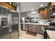 Well-lit kitchen featuring stainless steel appliances, light countertops, and neutral toned cabinetry at 5754 Shealy Ave, The Villages, FL 32163