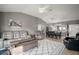 Cozy living area featuring a sectional sofa, center table, and decorative rug and modern design at 5754 Shealy Ave, The Villages, FL 32163