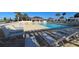 Resort-style pool with lounge chairs and overhead pergola in community at 5754 Shealy Ave, The Villages, FL 32163