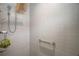 Modern shower with tiled walls, grab bar, and rain shower head fixture at 5754 Shealy Ave, The Villages, FL 32163