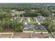 Aerial view showcasing the neighborhood, homes with backyard fences, and lush green landscape at 6873 Sw 131St Pl, Ocala, FL 34473