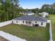 Aerial view of the property featuring a large yard, privacy fence, and patio area at 6873 Sw 131St Pl, Ocala, FL 34473