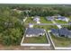 Aerial view of the property showcasing the well-maintained lawn and full white fence in a serene neighborhood at 6873 Sw 131St Pl, Ocala, FL 34473