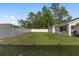 Spacious backyard featuring lush green lawn and a white fence providing privacy at 6873 Sw 131St Pl, Ocala, FL 34473