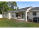 Backyard view highlighting a well-manicured lawn, patio, and privacy at 6873 Sw 131St Pl, Ocala, FL 34473