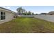 A long view of the grassy backyard with a white fence surrounding the property at 6873 Sw 131St Pl, Ocala, FL 34473