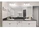 Elegant bathroom with double sinks, a large mirror, and vanity with black countertops at 6873 Sw 131St Pl, Ocala, FL 34473