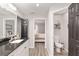 Bright bathroom with vanity, dark hardware, with toilet room and bedroom in view at 6873 Sw 131St Pl, Ocala, FL 34473