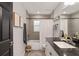 Bathroom with white vanity, black accents, tiled shower, and decorative accents at 6873 Sw 131St Pl, Ocala, FL 34473