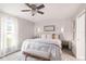 Bright bedroom with a stylish accent wall, bed, and bench, illuminated by modern sconces at 6873 Sw 131St Pl, Ocala, FL 34473