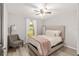 Bedroom with a bed, chair, wood-look floors, and natural light from the window at 6873 Sw 131St Pl, Ocala, FL 34473