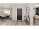Inviting entryway boasts new flooring, updated decor, and a stylish black door at 6873 Sw 131St Pl, Ocala, FL 34473