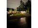 Charming single-story home with manicured lawn, palm trees, a white fence, and a two-car garage on a well-lit lot at 6873 Sw 131St Pl, Ocala, FL 34473