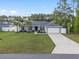 Charming single-story home with a well-manicured lawn, beautiful plants, and a two-car garage at 6873 Sw 131St Pl, Ocala, FL 34473