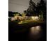 Charming single-story home with manicured lawn, palm trees, and a two-car garage on a well-lit lot at night at 6873 Sw 131St Pl, Ocala, FL 34473