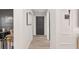 Bright hallway with wood-look floors leading to office, bedroom, and main living areas at 6873 Sw 131St Pl, Ocala, FL 34473