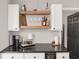 Kitchenette area featuring open shelving, countertop wine cooler, and a coffee bar at 6873 Sw 131St Pl, Ocala, FL 34473