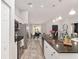 Modern kitchen featuring stainless steel appliances, granite countertops, and access to dining area at 6873 Sw 131St Pl, Ocala, FL 34473