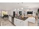 Open-concept kitchen with granite counters, stainless steel appliances, and a view of the living area at 6873 Sw 131St Pl, Ocala, FL 34473