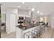 Kitchen island features stainless appliances, stone countertops, and comfortable bar stool seating at 6873 Sw 131St Pl, Ocala, FL 34473