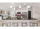 Bright kitchen island featuring stone countertops, stainless steel appliances, and barstool seating at 6873 Sw 131St Pl, Ocala, FL 34473