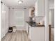 Bright kitchenette featuring open shelves and countertop wine cooler, and a large window at 6873 Sw 131St Pl, Ocala, FL 34473