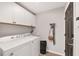 Well-equipped laundry room featuring sleek cabinets and modern washer and dryer at 6873 Sw 131St Pl, Ocala, FL 34473