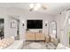 Bright living room featuring a modern cabinet, stylish decor, and a cozy seating area at 6873 Sw 131St Pl, Ocala, FL 34473