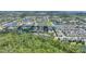 An aerial view showcases a townhome community surrounded by lush greenery and multiple serene ponds at 7752 Moser Ave, Windermere, FL 34786