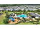 An aerial view of community amenities includes a pool, playground and nearby pond, surrounded by beautifully landscaped homes at 7752 Moser Ave, Windermere, FL 34786