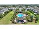 Aerial view of a resort-style community pool area with palm trees, cabanas, and ample seating for relaxation and recreation at 7752 Moser Ave, Windermere, FL 34786