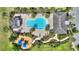 An aerial view displays a community pool with a playground, palm trees, and gazebo, set amongst well-maintained landscaping at 7752 Moser Ave, Windermere, FL 34786