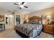 Comfortable bedroom features plush carpet, a ceiling fan, and a convenient walk-in closet at 7752 Moser Ave, Windermere, FL 34786