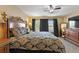 Spacious bedroom features a ceiling fan, plush carpet, and an oversized dresser with mirror at 7752 Moser Ave, Windermere, FL 34786