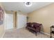 Neutral bedroom with a vintage couch, closet and natural light from a large window at 7752 Moser Ave, Windermere, FL 34786