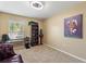 Neutral bedroom with a vintage chair, small desk, carpet and natural light from a large window at 7752 Moser Ave, Windermere, FL 34786