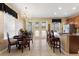 Elegant dining area with chandelier, table, and chairs next to the open kitchen at 7752 Moser Ave, Windermere, FL 34786