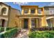 Charming two-story townhome featuring a covered entryway and neatly landscaped front yard at 7752 Moser Ave, Windermere, FL 34786