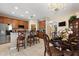 Open kitchen with stainless steel appliances, granite countertops, and adjacent dining area at 7752 Moser Ave, Windermere, FL 34786
