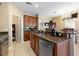 Open kitchen featuring stainless steel appliances, stone countertops and easy access to dining area at 7752 Moser Ave, Windermere, FL 34786