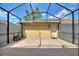 Enclosed patio area featuring brick floors, neutral walls, and a back entry door at 7752 Moser Ave, Windermere, FL 34786
